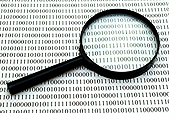 Image: magnifying glass on top of computer code.